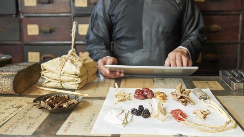 Man working in a traditional Chinese pharmacy