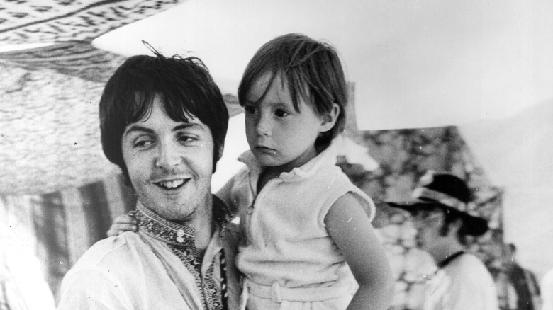 Paul McCartney holding Julian Lennon as a child