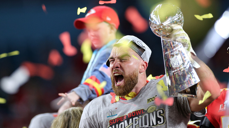 Travis Kelce celebrates with trophy