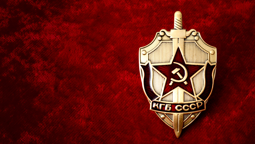 cold war era KGB badge from the former USSR on red velvet