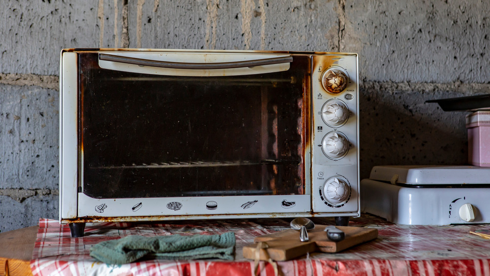 an old, burnt microwave on a table