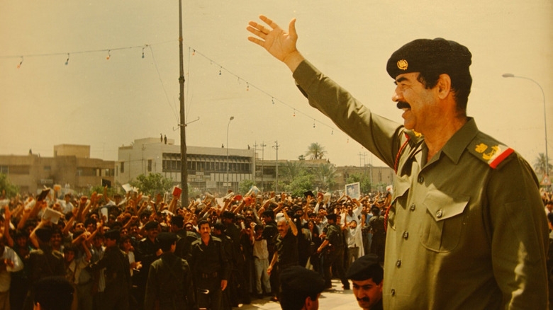 Saddam Hussein greeting people 