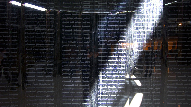 Names of victims of the March 16, 1988 chemical attacks on Halabja are shown on a memorial on black obsidian looking stone