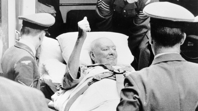 Winston Churchill carried into an ambulance