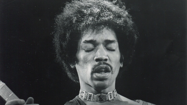 Black and grey photo of Jimi Hendrix performing live