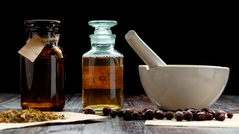 Oils and herbs with pestle