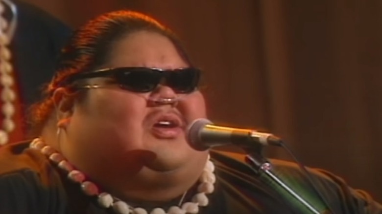 Israel Kamakawiwo'ole performing on stage sunglasses