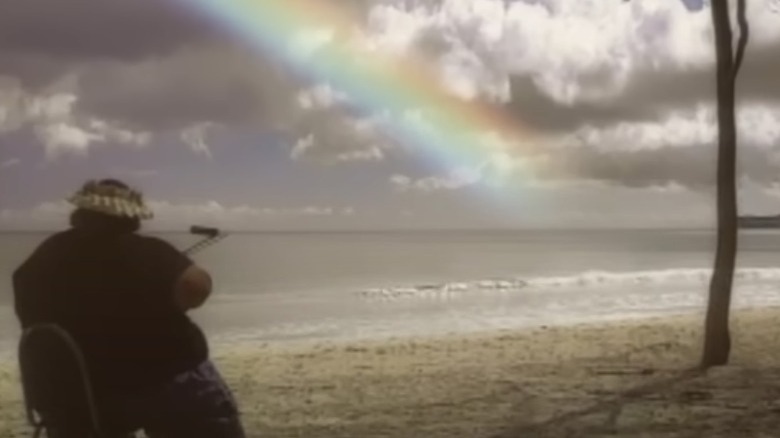 Kamakawiwo'ole sat on beach rainbow playing 