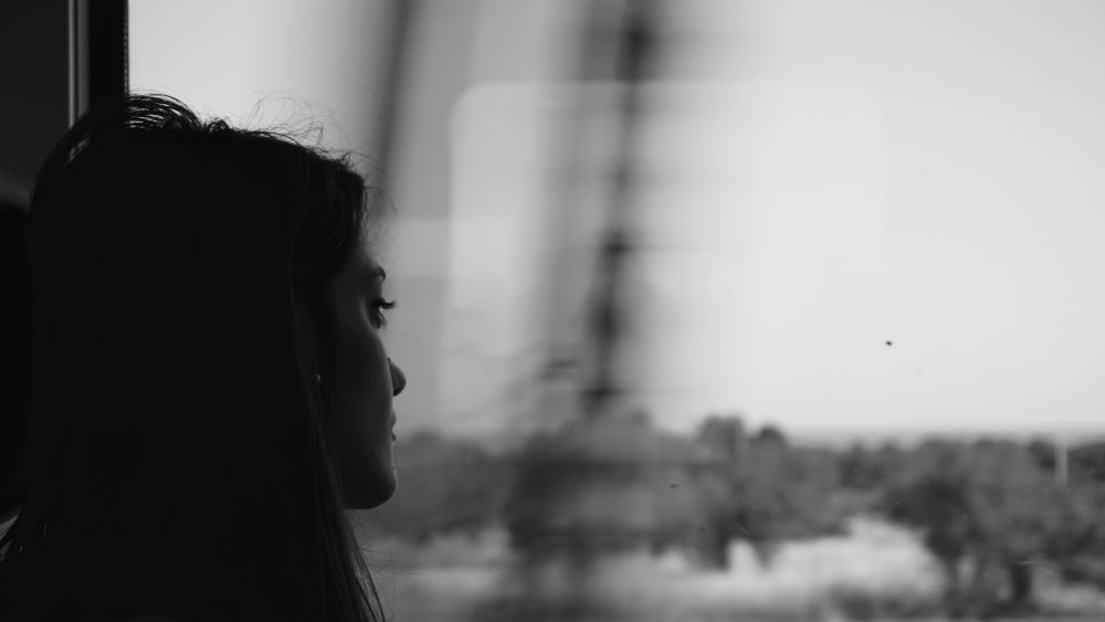 Sad woman looking out window