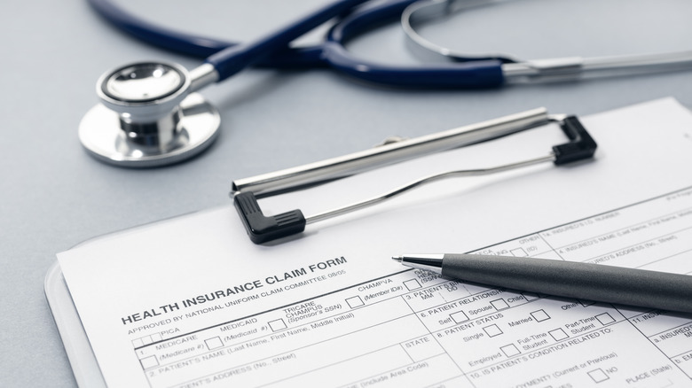 health insurance form on clipboard with stethoscope