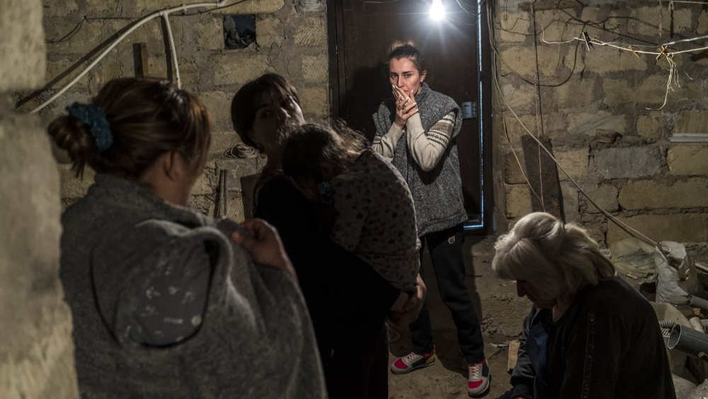 Residents shelter in a basement as air raid sirens sound on September 29, 2020 in Stepanakert, Nagorno-Karabakh. 