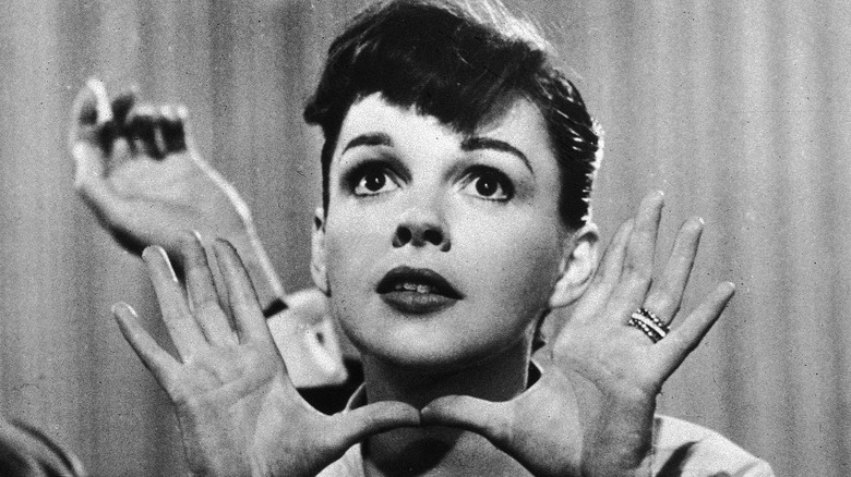 Judy Garland with hands raised