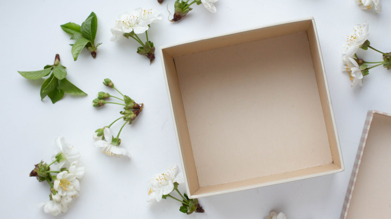 Empty box surrounded by flowers