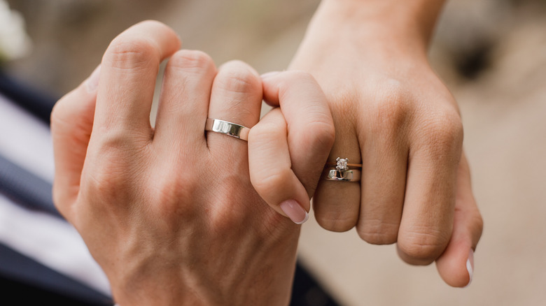 interlocked hands with rings