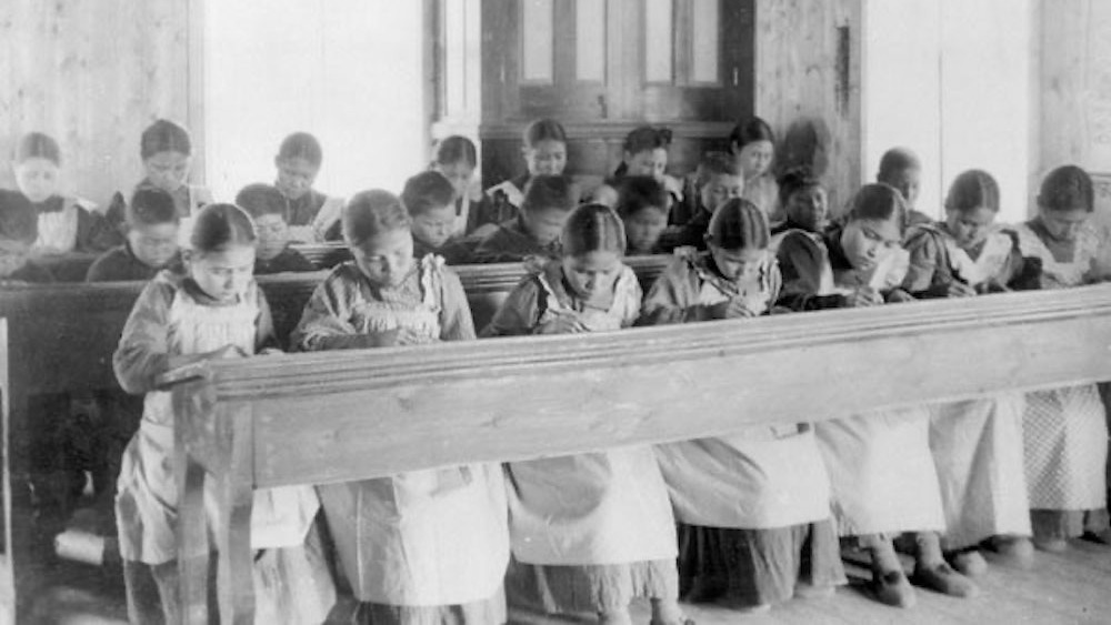 Canadian Indigenous residential school with students at desk