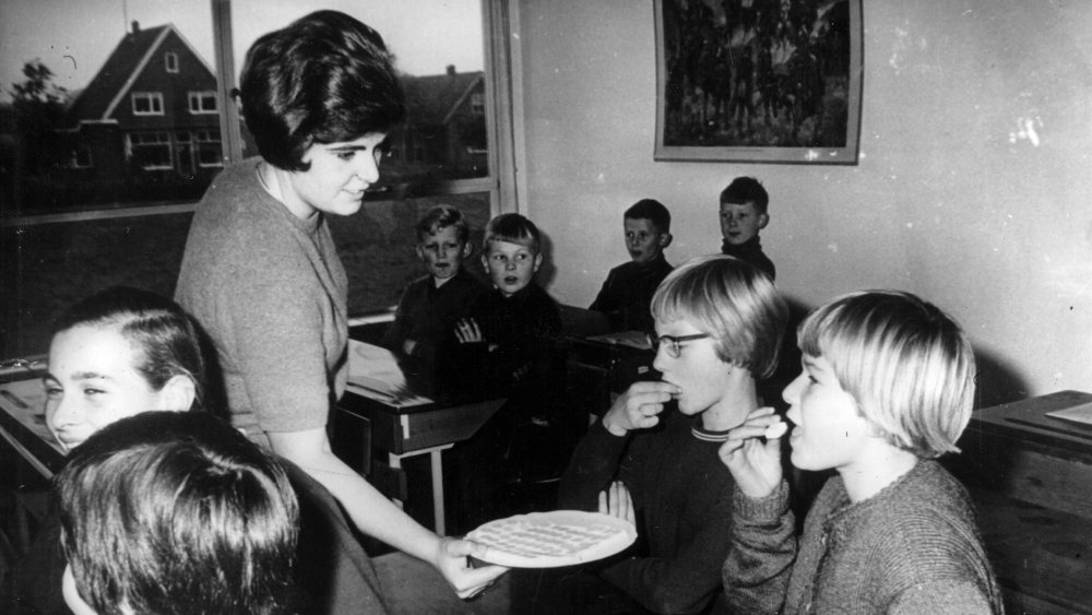 Two schoolchildren in Ermslo, Holland take their oral polio vaccines