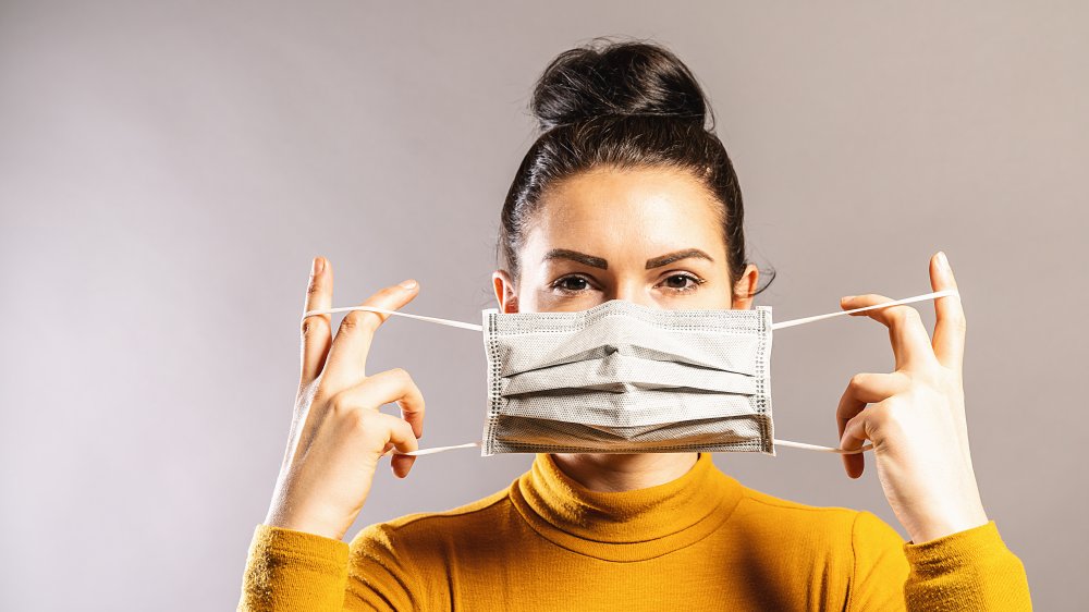 Woman putting on a medical mask