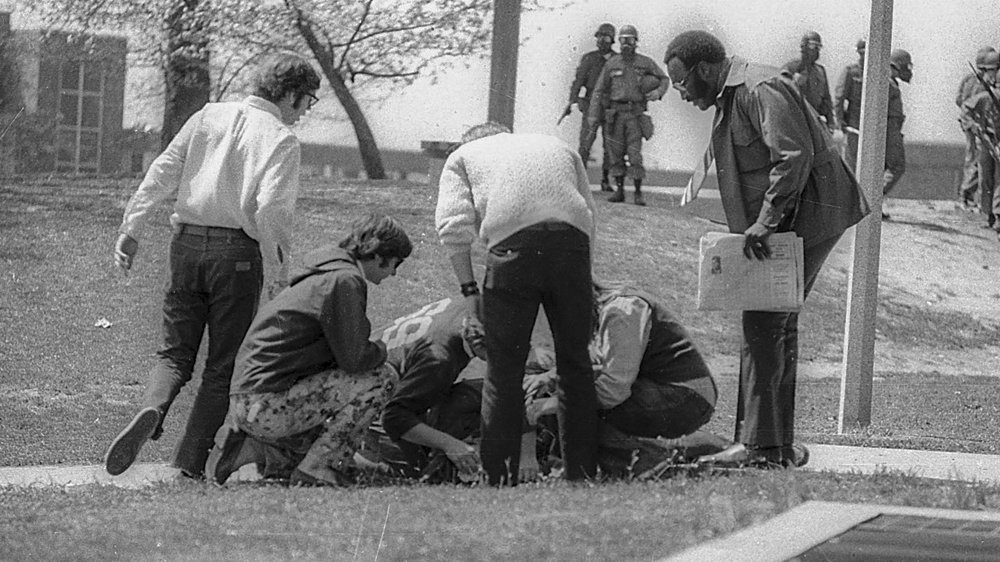 Kent State students and others kneel beside injured Joseph Lewis