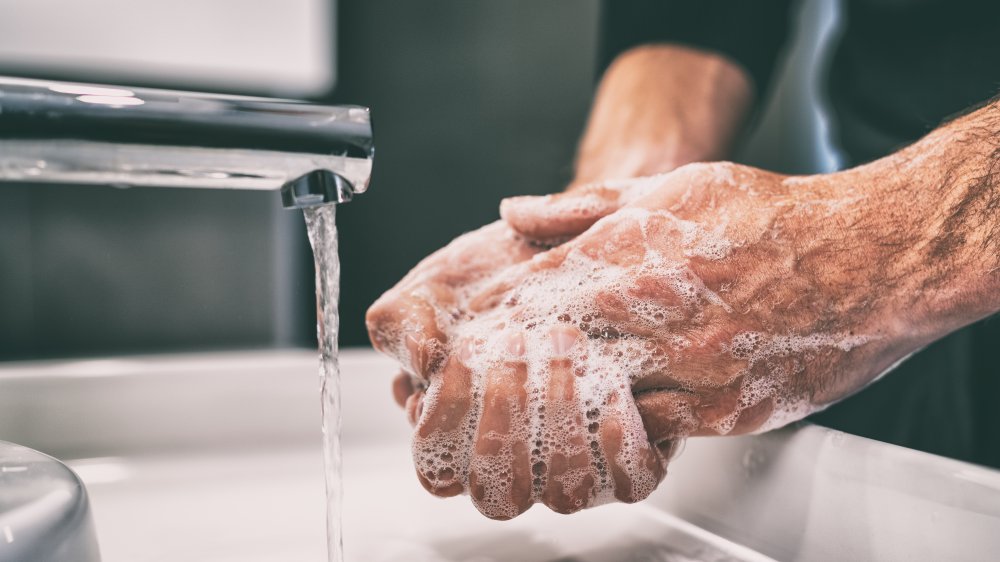 Washing hands under hot water