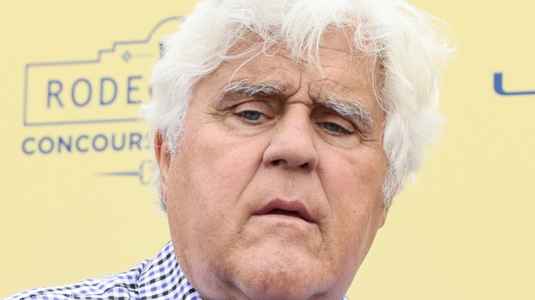 Jay Leno in plaid shirt glaring at camera