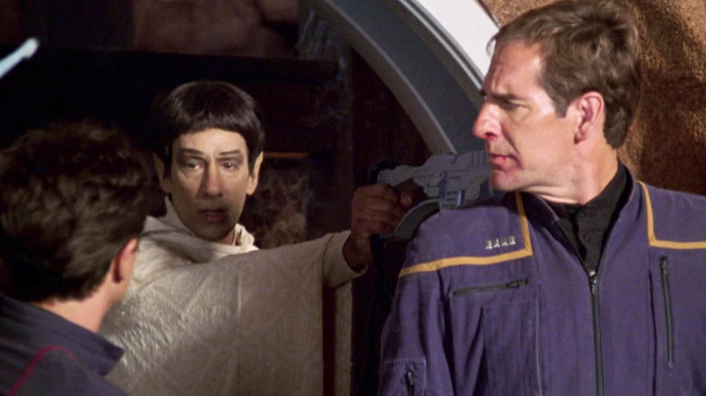 Screenshot from The Andorian Incident episode of Star Trek: Enterprise showing Vulcan monk with phaser on captain Archer.