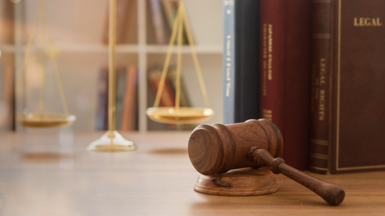 A gavel in front of law books