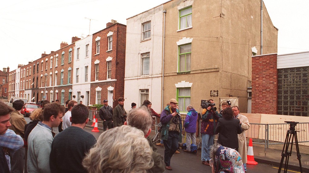 Crowd outside 25 Cromwell St. Gloucester 