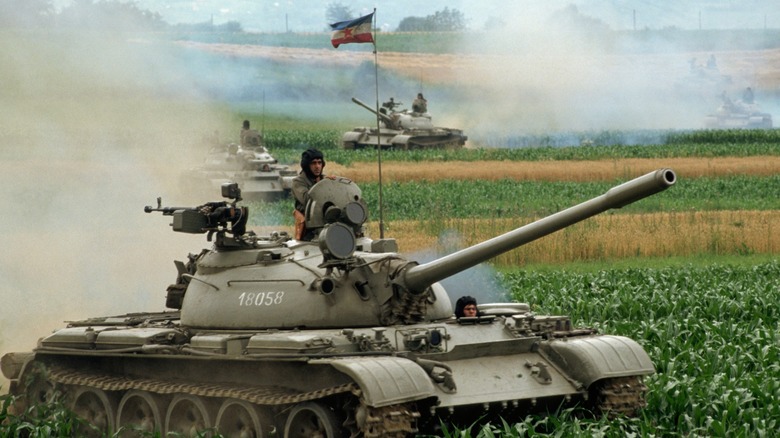 Soldier riding in tank battlefield