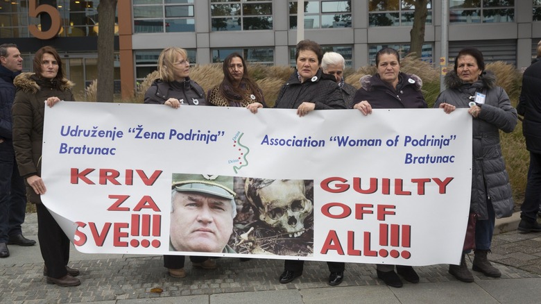 Female protestors holding anti-Mladic signs 
