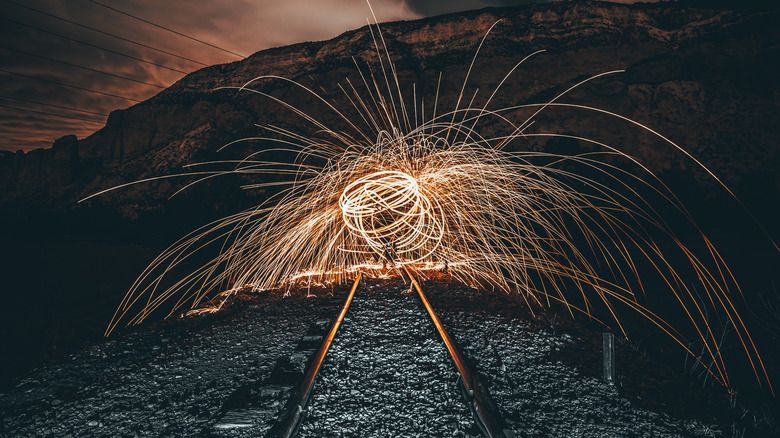 fire sparks over train tracks