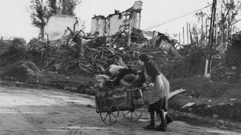 German women pushing their belongings