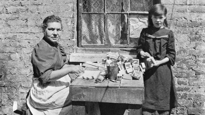 girl and woman putting together matchboxes