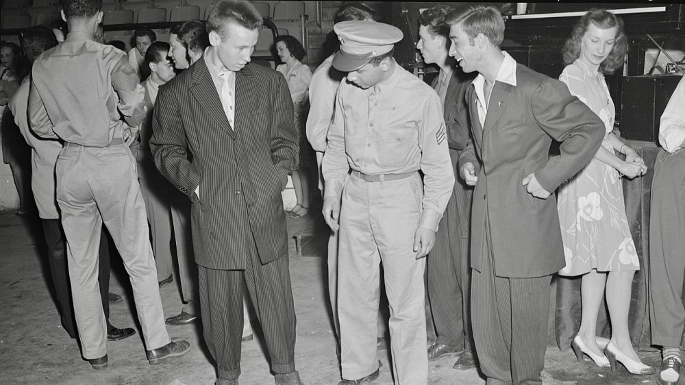 Washington, D.C. Soldier inspecting a couple of "zoot suits" at the Uline Arena during Woody Herman's Orchestra engagement there, 1942