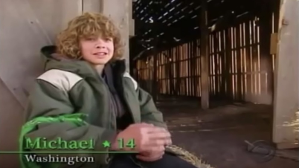 Mike sitting in front of an empty barn