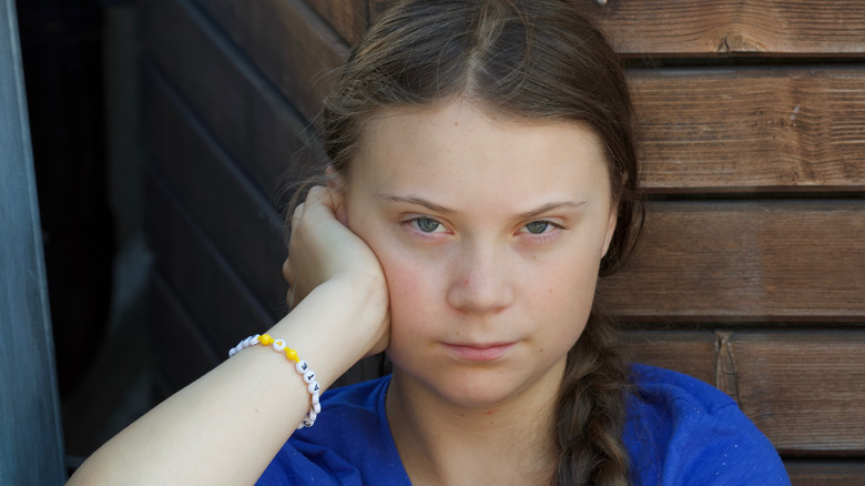 Greta Thunberg frowning in blue shirt