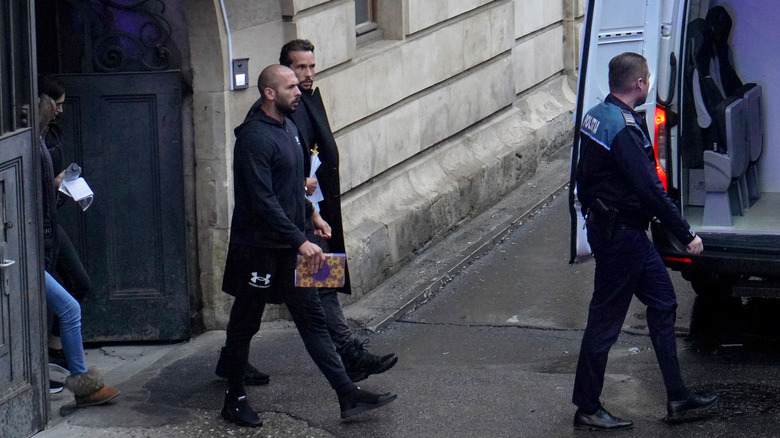 Andrew Tate entering police van