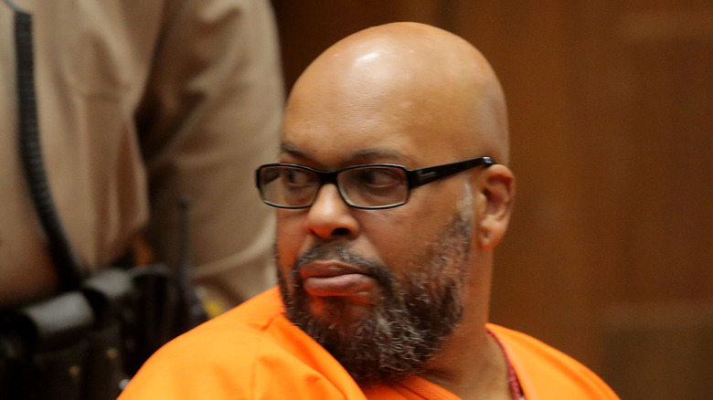 Suge Knight looks over his shoulder
