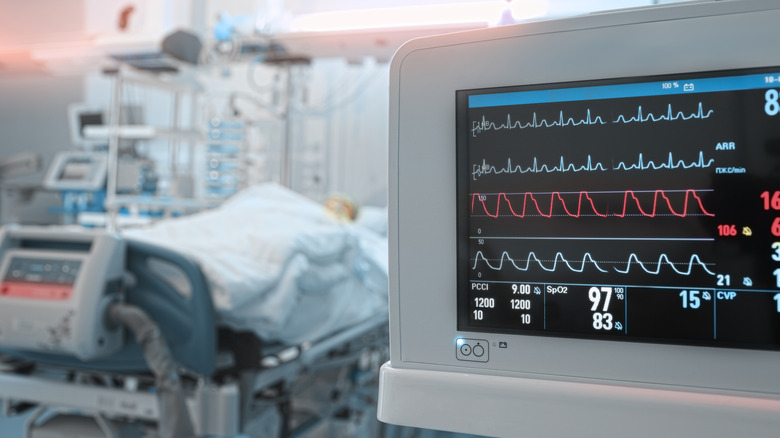 ECG machine and patient in hospital bed