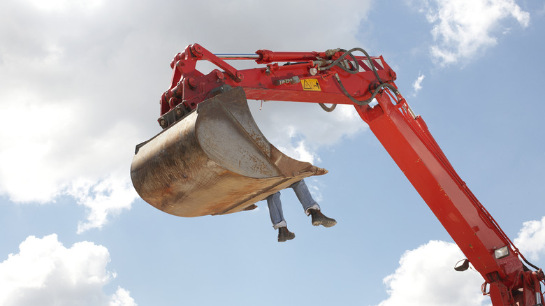 Excavator picks up a person