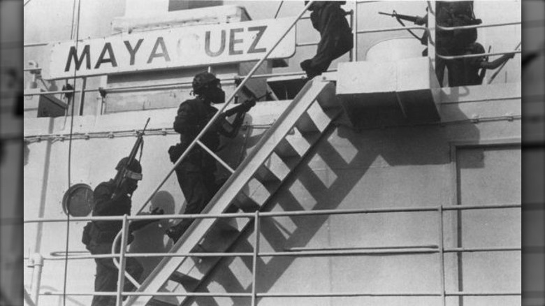 Armed soldiers boarding mayaguez ladder