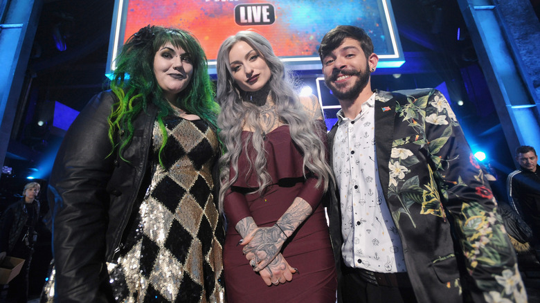 Ryan Ashely posing with Ink Master contestant on stage