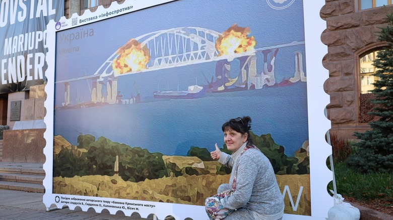 Woman posing in front of Ukraine stamp