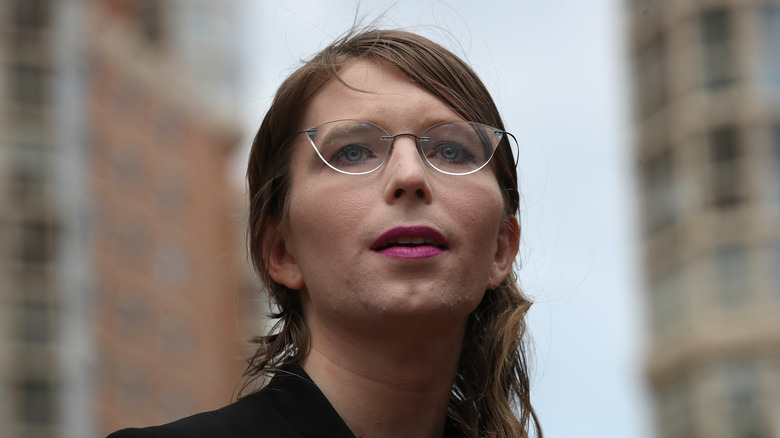 Chelsea Manning with glasses looking up outside