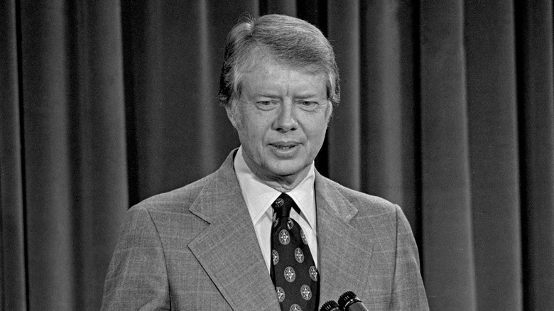 President Jimmy Carter stood talking in suit at press conference