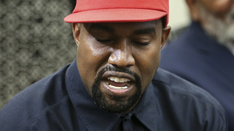 kanye west wearing a maga hat