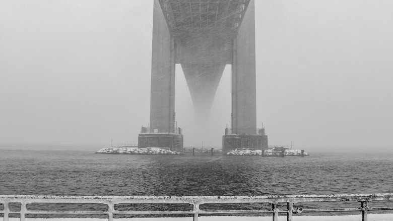 New York's Verrazzano-Narrows Bridge during a snowstorm in black and white