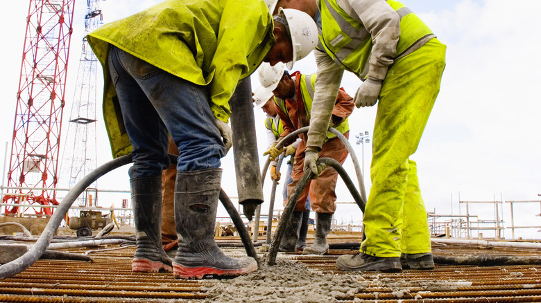 Concrete finishers at work pumping concrete