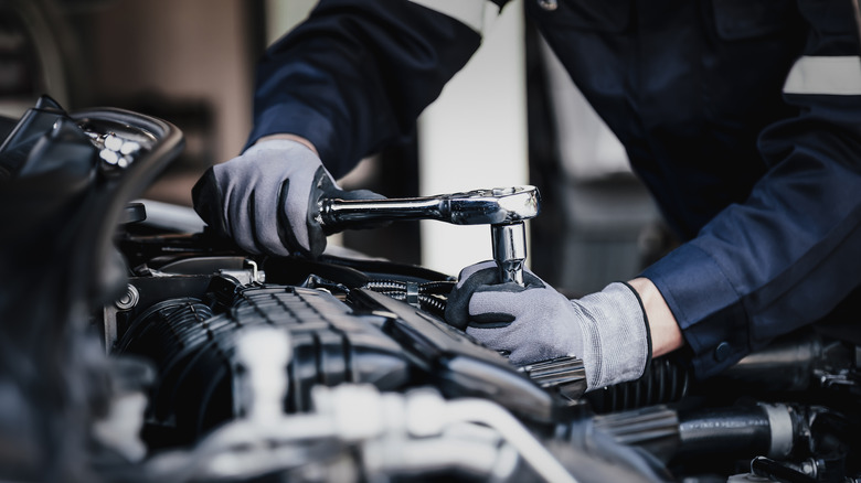 Professional mechanic working on an engine