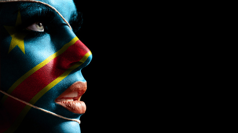 woman face painted DRC flag