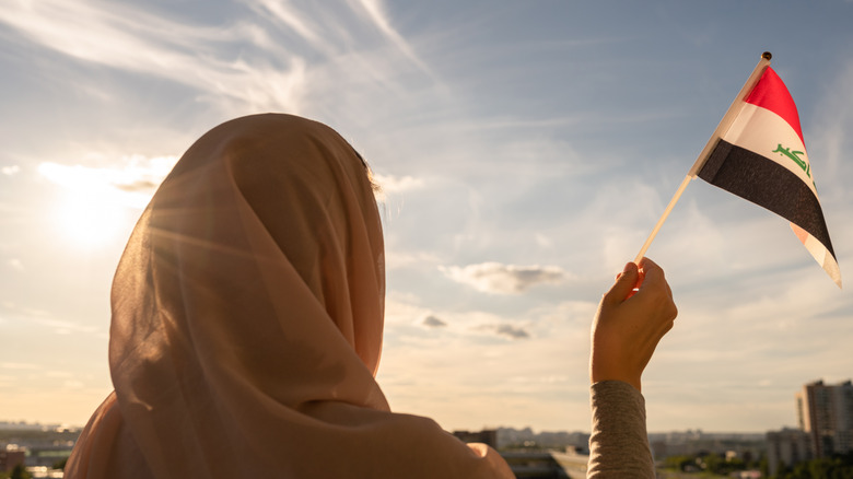 Iraq woman waving flag